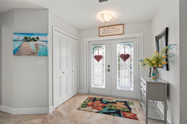 entryway featuring french doors and baseboards