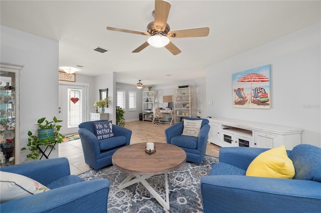 living room featuring visible vents and light tile patterned floors