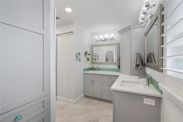 bathroom with recessed lighting, marble finish floor, vanity, and baseboards