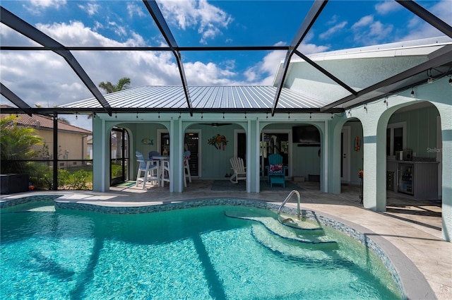 pool featuring a lanai, a patio area, and ceiling fan