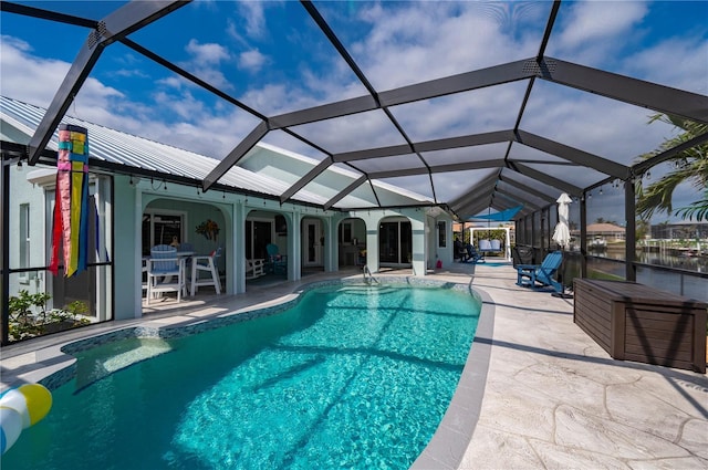 outdoor pool featuring glass enclosure and a patio