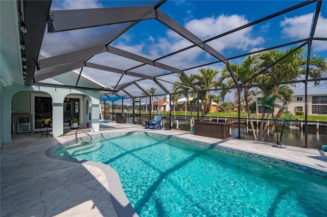 pool featuring a patio area, a lanai, and a water view