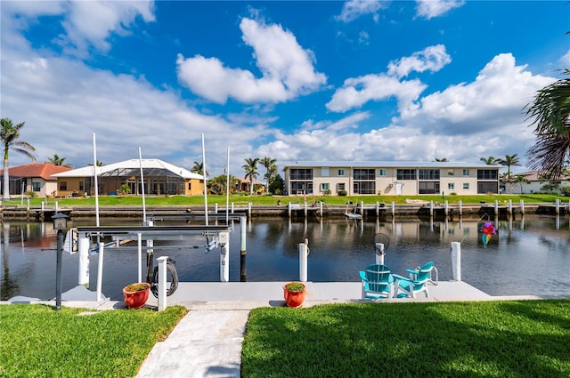 dock area featuring a yard, a water view, boat lift, and a residential view