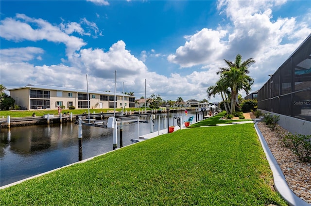 dock area featuring a residential view, glass enclosure, a water view, and a lawn