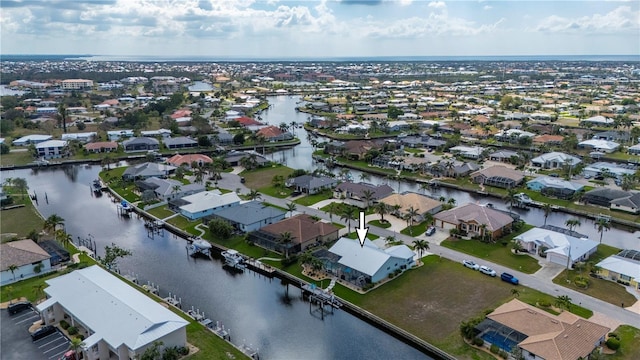 birds eye view of property with a water view and a residential view