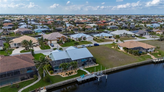 drone / aerial view with a water view and a residential view