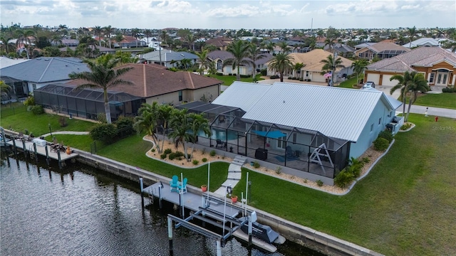 birds eye view of property with a water view and a residential view