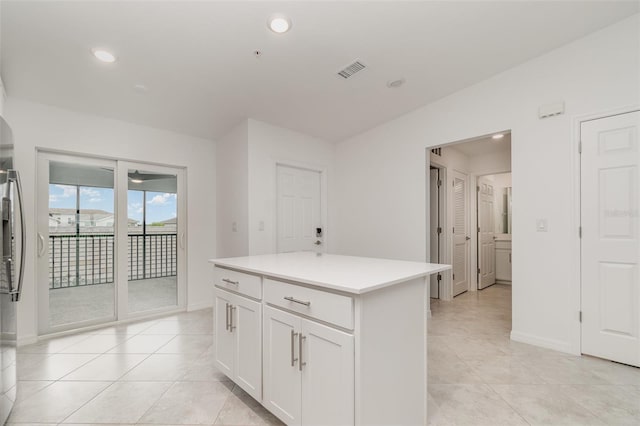 kitchen with recessed lighting, light countertops, visible vents, white cabinetry, and a kitchen island