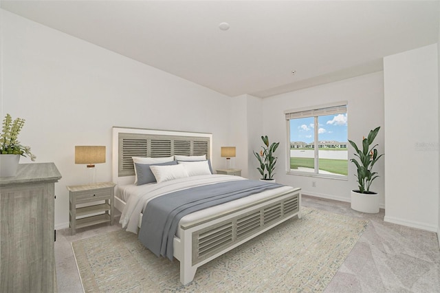 bedroom featuring light carpet and baseboards