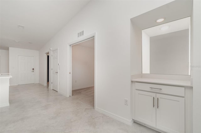 corridor featuring visible vents and baseboards