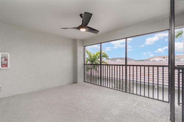 unfurnished sunroom featuring ceiling fan