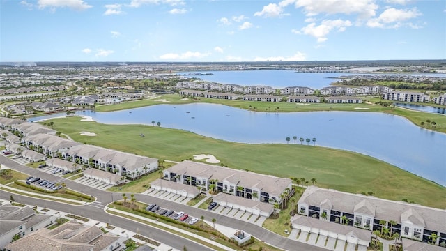 drone / aerial view with a water view, a residential view, and golf course view