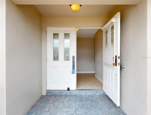 doorway to property featuring stucco siding