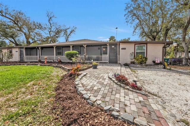 single story home featuring a front yard and stucco siding