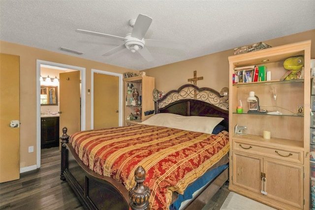 bedroom with a textured ceiling, visible vents, baseboards, a ceiling fan, and dark wood finished floors