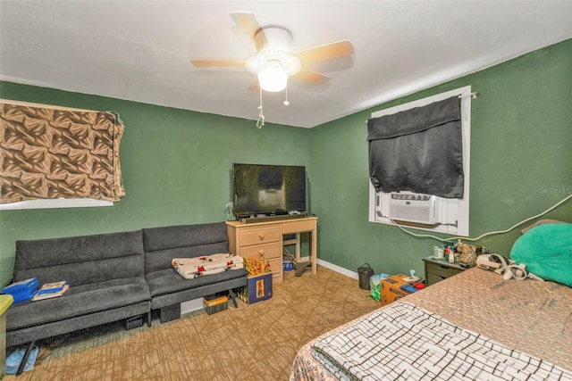 bedroom with light floors, ceiling fan, baseboards, and cooling unit