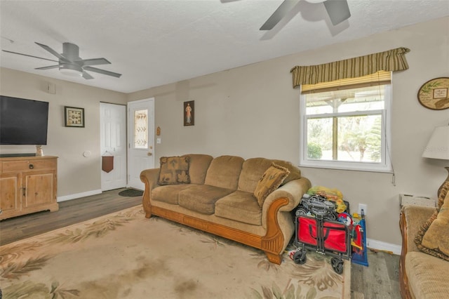 living room with ceiling fan, wood finished floors, and baseboards