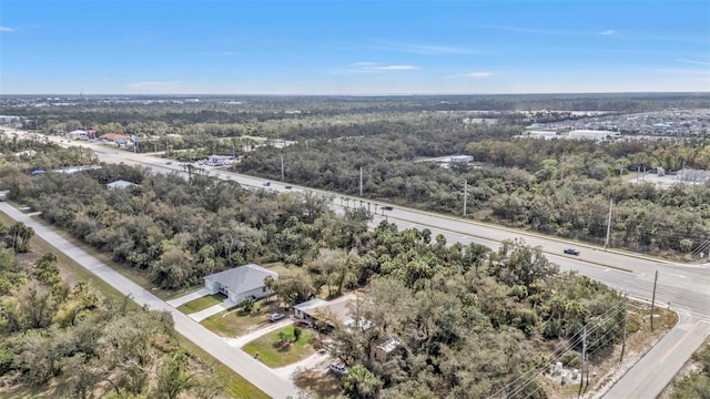 drone / aerial view featuring a wooded view