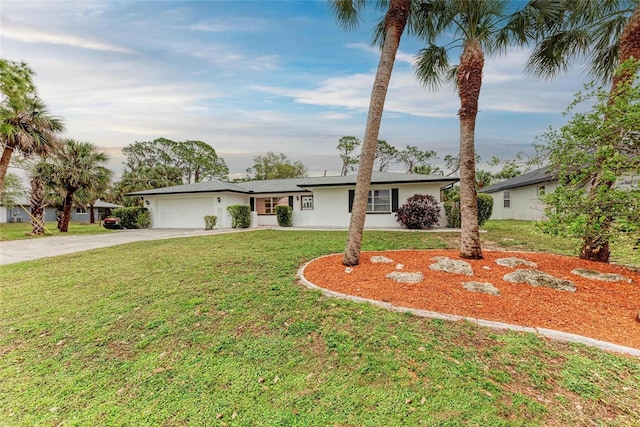 1052 Hinton St, Port Charlotte, FL 33952 - ranch-style home with stucco siding, an attached garage, concrete driveway, and a front lawn
