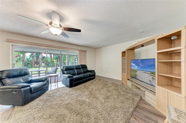 1052 Hinton St, Port Charlotte, FL 33952 - living area with a textured ceiling, wood finished floors, and ceiling fan