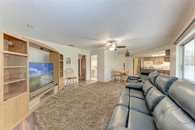 1052 Hinton St, Port Charlotte, FL 33952 - living area with visible vents, a textured ceiling, a ceiling fan, and wood finished floors