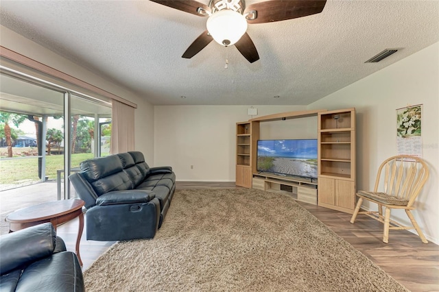 1052 Hinton St, Port Charlotte, FL 33952 - living room with visible vents, baseboards, wood finished floors, a textured ceiling, and a ceiling fan