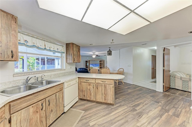 1052 Hinton St, Port Charlotte, FL 33952 - kitchen featuring light wood-type flooring, a sink, a peninsula, light countertops, and dishwasher