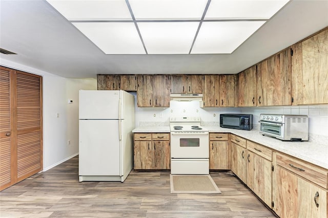 1052 Hinton St, Port Charlotte, FL 33952 - kitchen featuring light wood-type flooring, white appliances, range hood, and light countertops