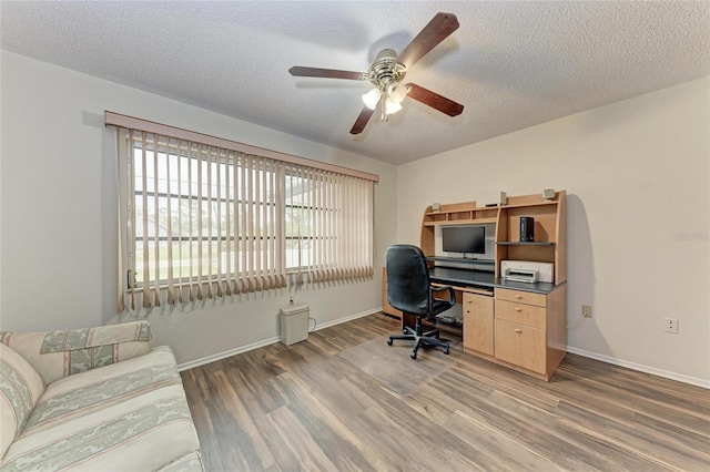 1052 Hinton St, Port Charlotte, FL 33952 - office area with light wood-type flooring, baseboards, a textured ceiling, and a ceiling fan