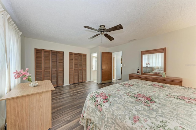 1052 Hinton St, Port Charlotte, FL 33952 - bedroom with dark wood-type flooring, two closets, ceiling fan, and a textured ceiling