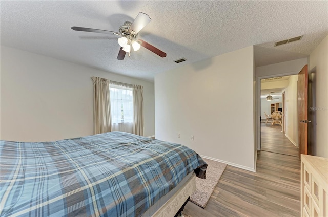 1052 Hinton St, Port Charlotte, FL 33952 - bedroom with a ceiling fan, wood finished floors, visible vents, and baseboards