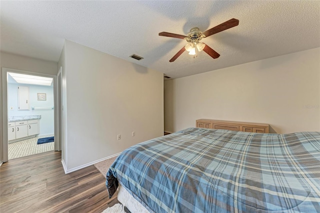 1052 Hinton St, Port Charlotte, FL 33952 - bedroom featuring visible vents, ceiling fan, baseboards, wood finished floors, and a textured ceiling