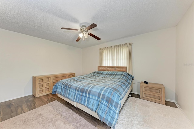 1052 Hinton St, Port Charlotte, FL 33952 - bedroom with baseboards, a textured ceiling, wood finished floors, and a ceiling fan