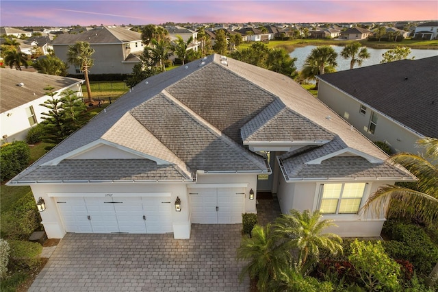 drone / aerial view featuring a water view and a residential view