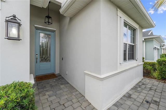 view of exterior entry with stucco siding