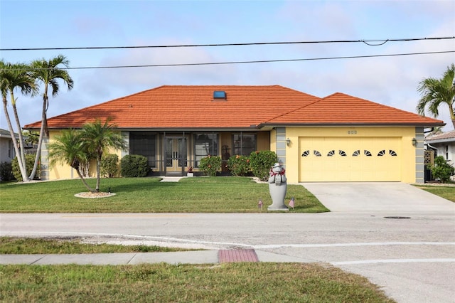 view of front of house with a garage, driveway, a front lawn, and stucco siding