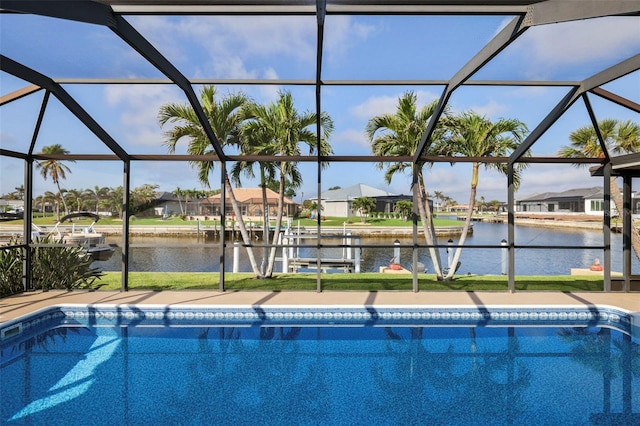 view of pool featuring a residential view, glass enclosure, and a water view