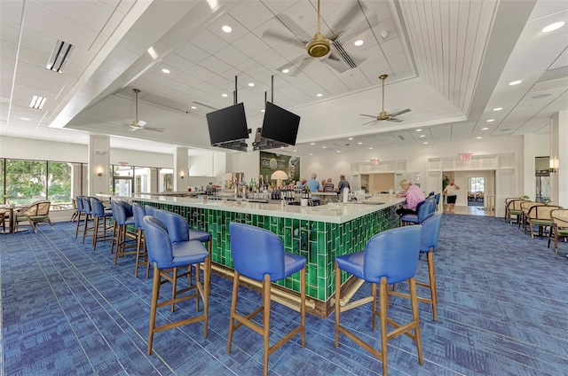 3 Bermuda Cir Unit 49, Englewood, FL 34223 - bar area with dark colored carpet, a ceiling fan, recessed lighting, and a raised ceiling