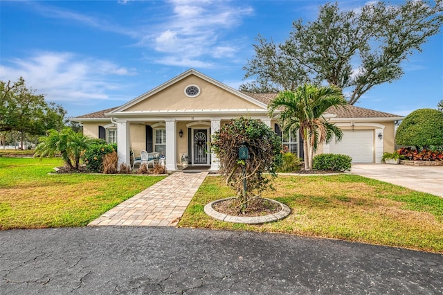 3 Bermuda Cir Unit 49, Englewood, FL 34223 - greek revival inspired property with stucco siding, driveway, an attached garage, a front lawn, and covered porch
