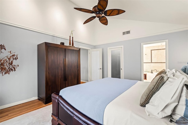 bedroom featuring lofted ceiling, wood finished floors, a ceiling fan, visible vents, and baseboards