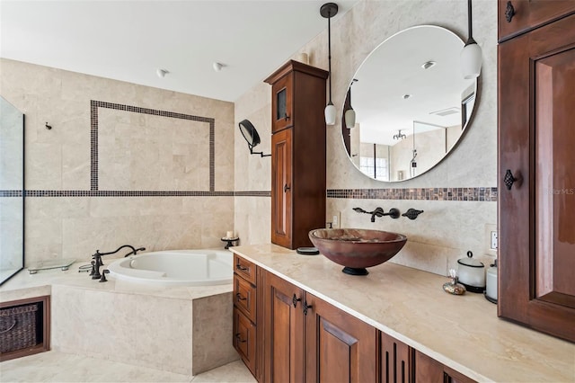 full bath with a bath, vanity, and tile walls