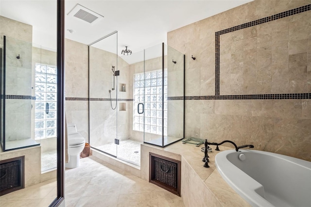 full bath with a stall shower, visible vents, tile walls, tile patterned flooring, and a bath