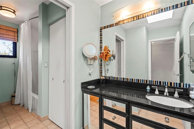 bathroom with a skylight, tile patterned flooring, vanity, and shower / tub combo with curtain