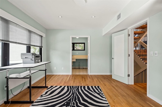 home office featuring baseboards, visible vents, wood finished floors, and recessed lighting