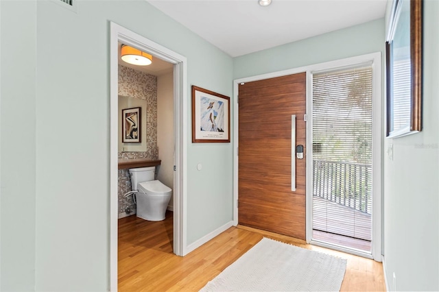 entryway featuring light wood-style floors and baseboards