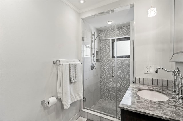 full bathroom with ornamental molding, a shower stall, and vanity