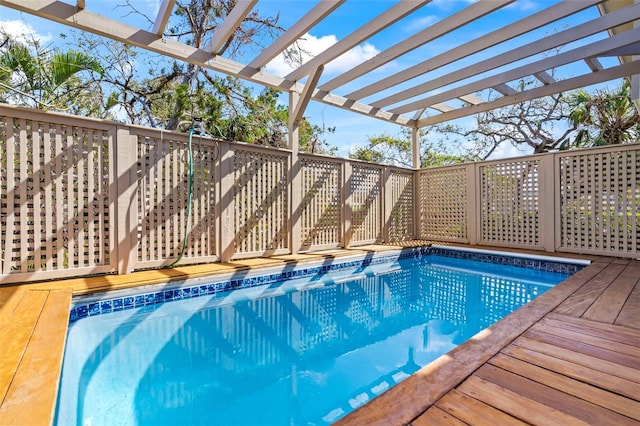 view of swimming pool with a pergola, a fenced in pool, and a wooden deck