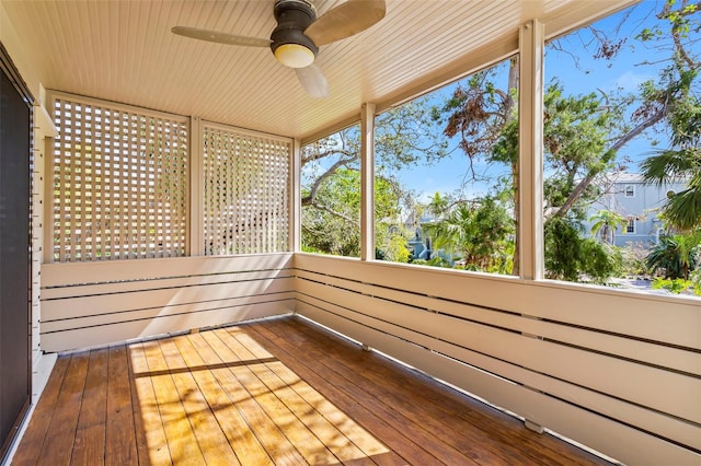 unfurnished sunroom with ceiling fan