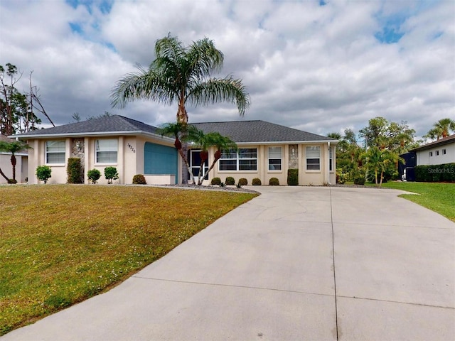 single story home featuring a front yard, driveway, an attached garage, and stucco siding