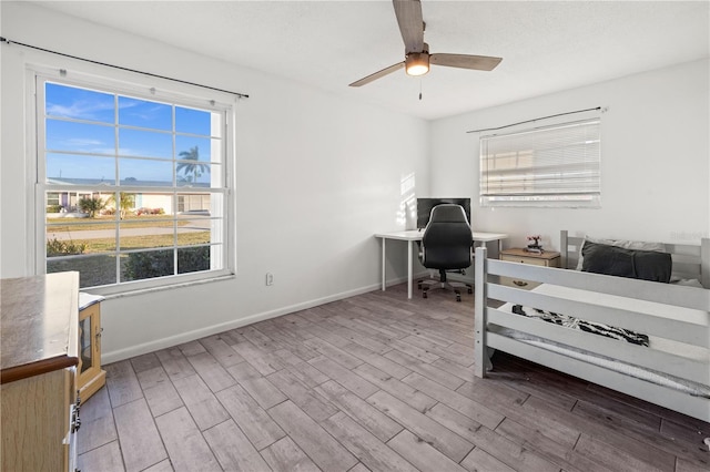 3265 Sunrise Trl, Port Charlotte, FL 33952 - bedroom featuring wood finished floors, an office area, and ceiling fan